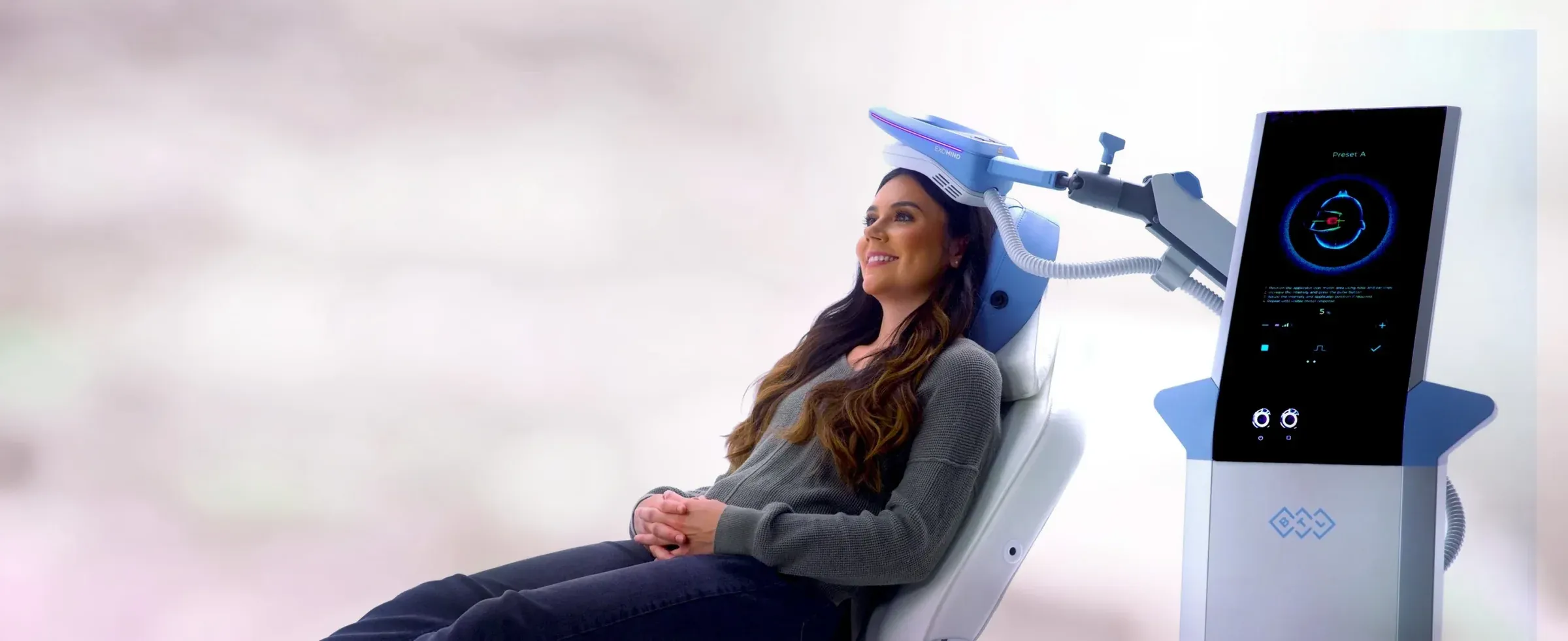 Client seated in the ExoMind treatment chair during a session