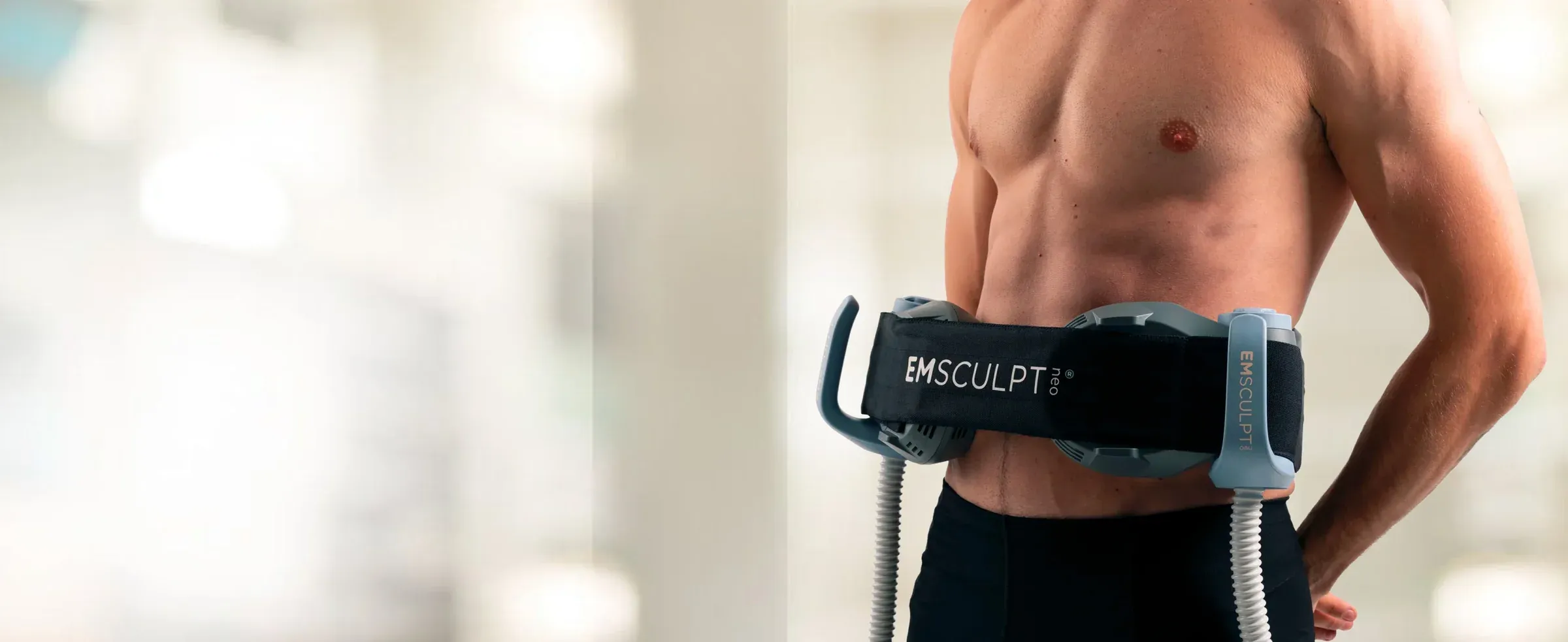 Patient wearing Emsculpt Neo applicator — body shaping treatment