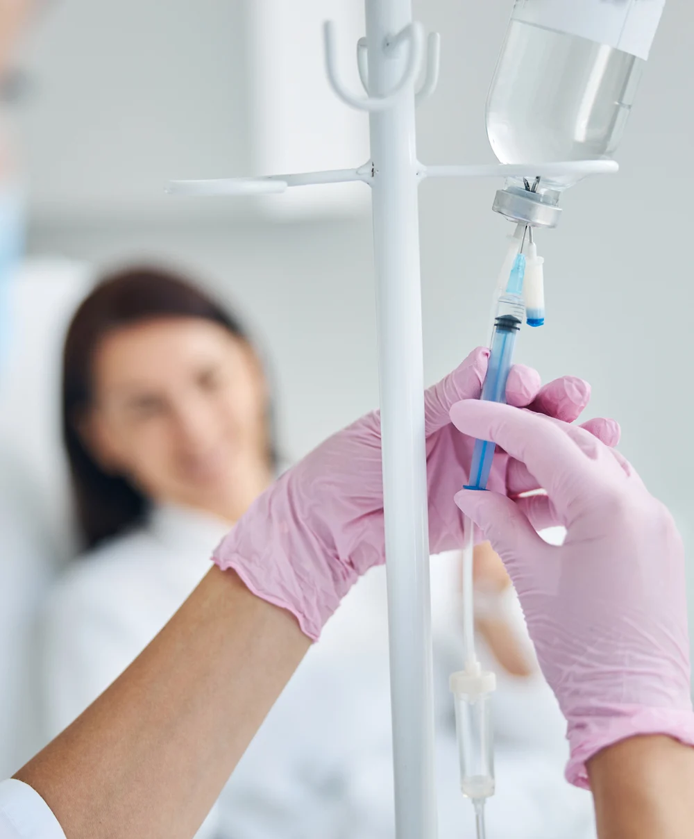 Patient receiving IV therapy as a clinician administers the infusion — Ideal Medical, Aventura